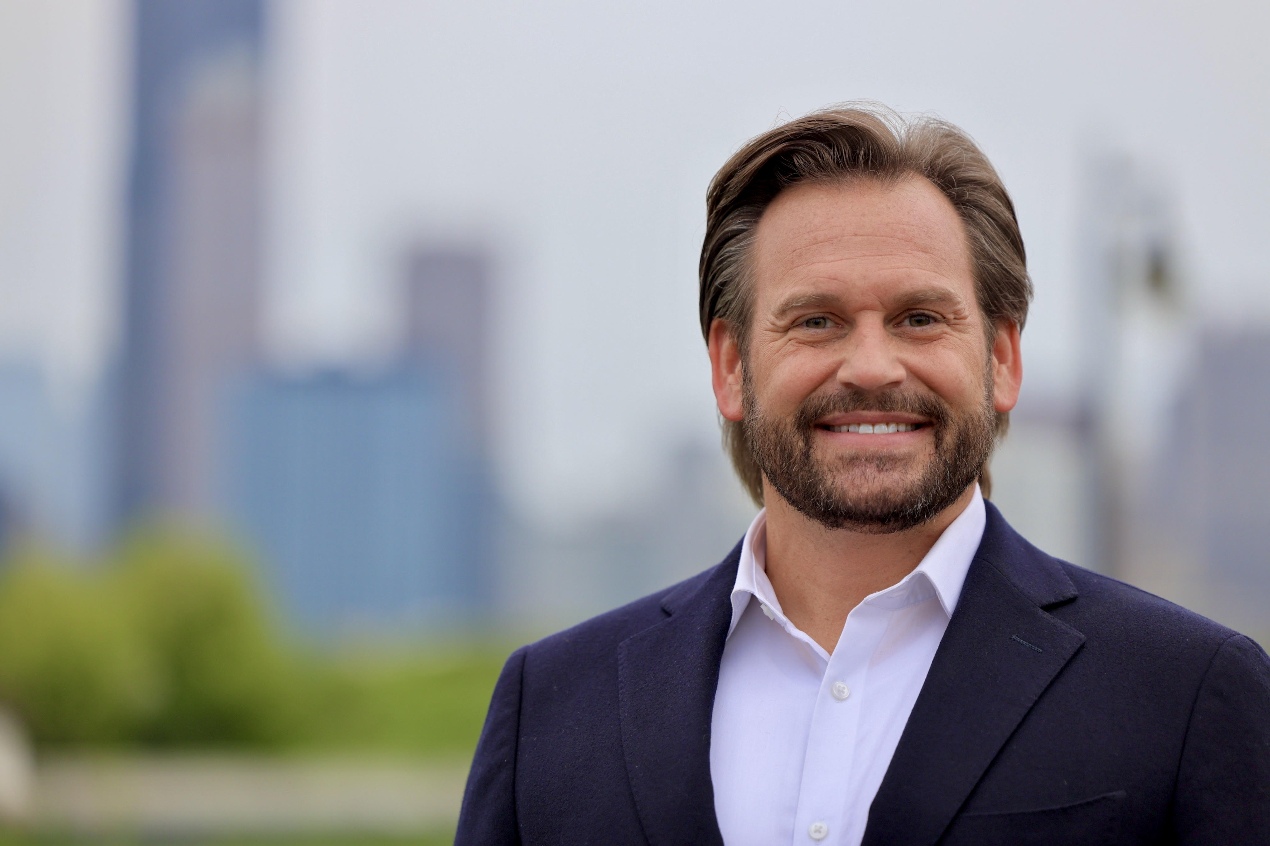 Dan Balanoff, attorney, with the Chicago skyline behind him