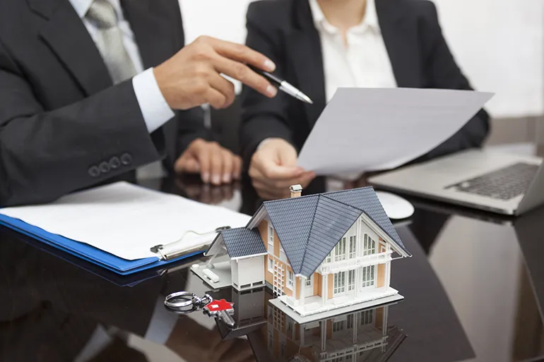 Reviewing documents at a real estate closing table